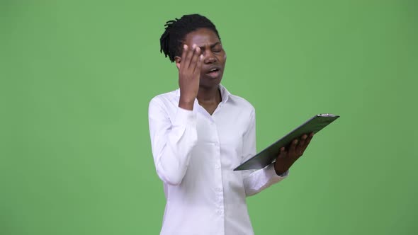 Young Beautiful African Businesswoman Reading on Clipboard