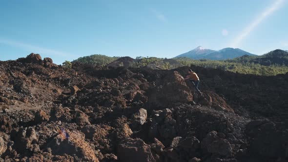 Tourist Man Climbed to the Top of a Volcanic Stone