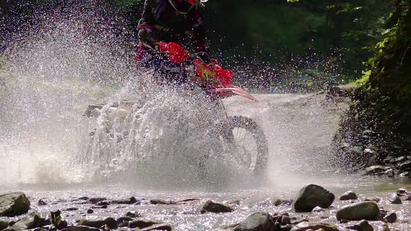 Motocycle Rider Crosses Mountain River