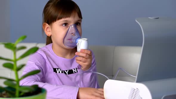 Little Girl Turn on Nebulizer to Make Inhalation with Medical Inhaler at Home