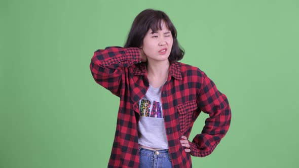Stressed Asian Hipster Woman Having Neck Pain