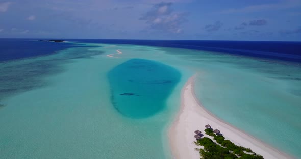 Natural birds eye travel shot of a white sandy paradise beach and blue sea background in colourfu