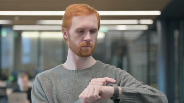 Portrait of Young Man Using Smart Watch