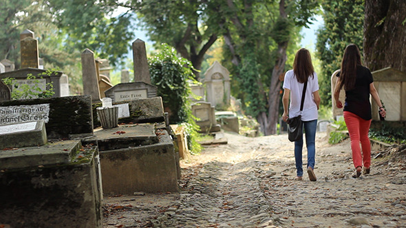 Two Girls Walking in Cemetery
