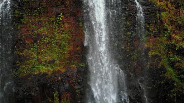 Aerial drone camera shoots water falling in a Opaekaa falls in Kauai, Hawaii, USA