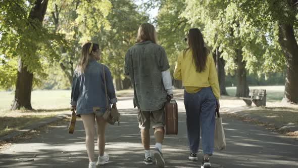 Back View Relaxed Hippies Walking Sunny Summer Park Talking