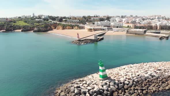 Cais da Solaria and small Fort of Ponta da Bandeira with Lagos cityscape in background, Algarve