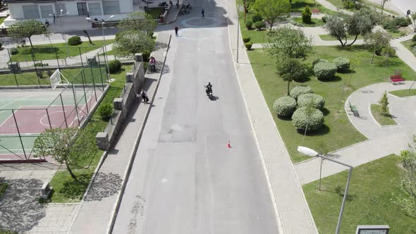 Motorcyclists ride through cones. Exersice for beginners and experienced.