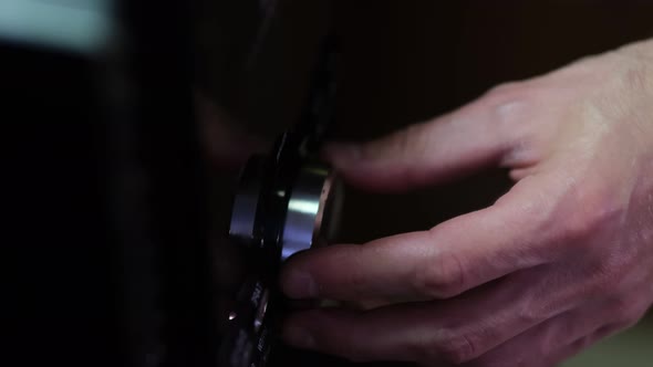 Man's Hand Adjiusting Volume Knob of Subwoofer Audio Amplifiervolume Control Music Concept