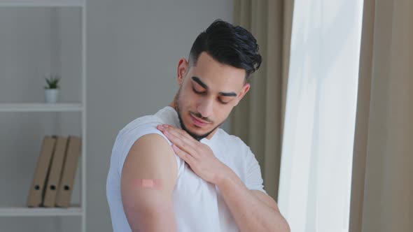 Portrait of Arabic Ethnic Hispanic Man Guy Patient Shows Medical Plaster on Shoulder Demonstrates