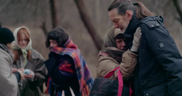 Senior Man Consoling Crying Immigrant Woman