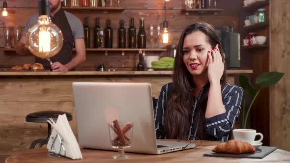 Beautiful Woman Listens To Her Favorite Song While Working on Her Laptop