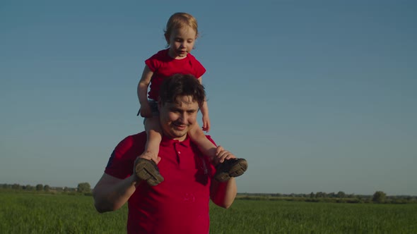 Positive Dad Giving Piggyback Ride To Baby Girl