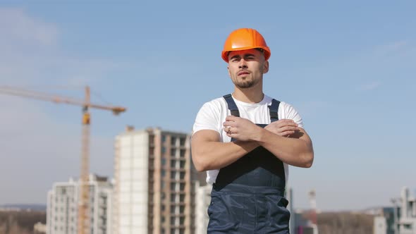 The Young Engineer is Looking at the Camera and Crossing His Arms