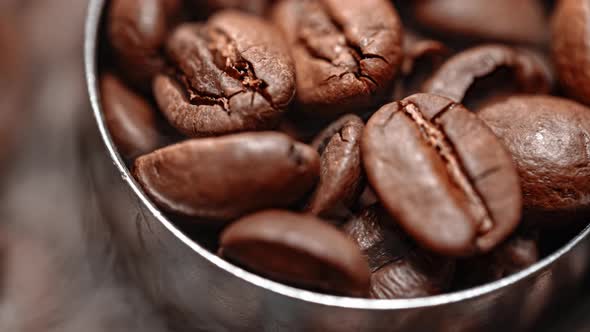 Close Up of Seeds of Coffee. Fragrant Coffee Beans Are Roasted Smoke Comes From Coffee Beans.