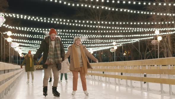 Big Family Ice-Skating On Rink