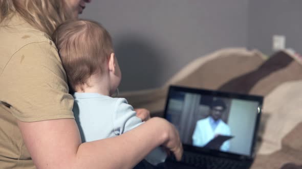 Telemedicine concept - young woman video chat with family doctor talking about her sick daughter.