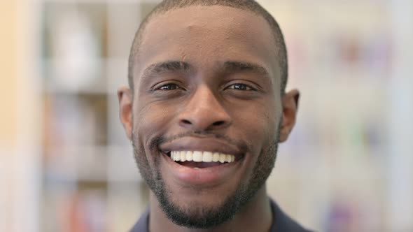 Close Up of Smiling Young African Man Looking at the Camera