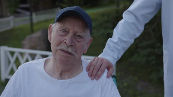 Close Up Old Bearded Man Watches on the Camera