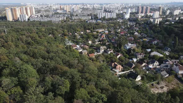 Megalopolis Next To the Forest: the Contact Between the Big City and Nature. Aerial View. Slow