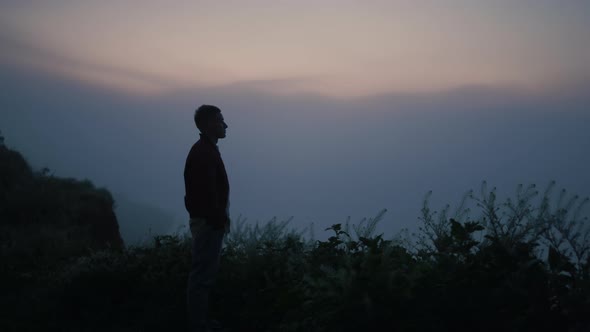 Sad Man Silhouette Standing on Mountain Top