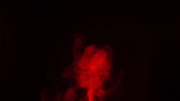 Slow motion of red smoke, fog, mist, vapor on a black background.