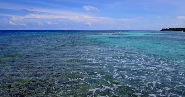 Luxury flying abstract view of a white sandy paradise beach and blue sea background in colorful 4K