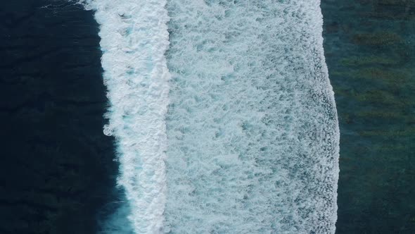 Slowmotion Top Down Aerial View of the Ocean Giant Waves Foaming and Splashing