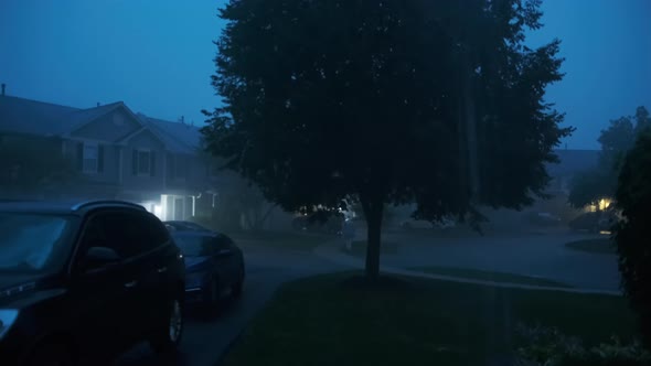 Hard Storm with Loud Thunder and Lightning a Suburban Residential Street at Night Time