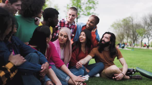 Group of young multiracial friends having fun together in park - Friendship and diversity concept