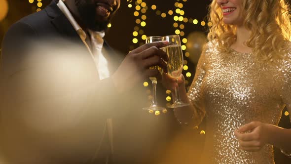 Happy Mixed-Race Couple Clinking Champagne Glasses Party, New Year Celebration
