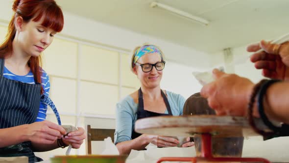 Artist molding clay at table 4k