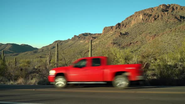 Tucson Mountain Park. Tucson, Arizona. Cars drive past in the foreground, on Gates Pass Road.