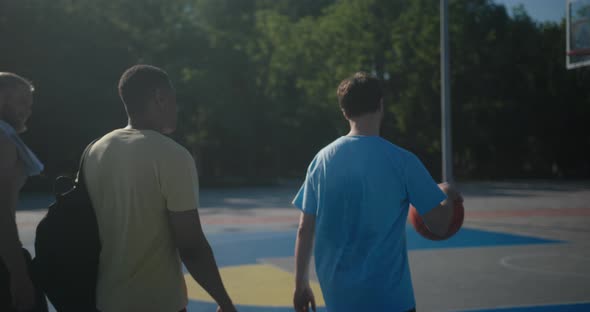 Basketball Players Prepare to Play Basketball in City Yard