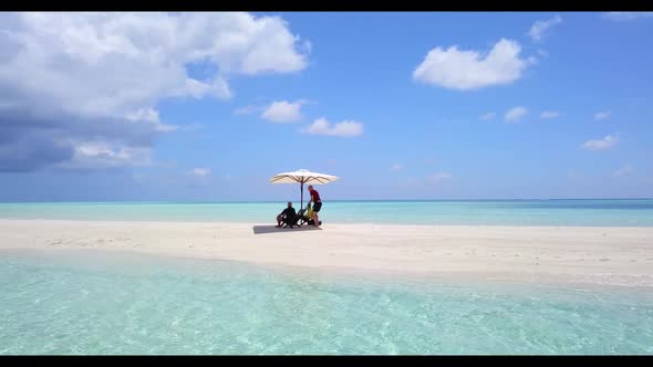 Teenage lovers relax on perfect sea view beach break by clear sea with white sandy background of the