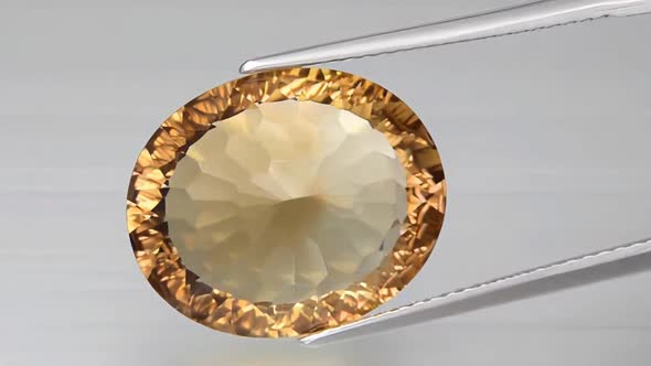 Imperial Champagne Yellow Topaz Oval Cut in the Turning Tweezers