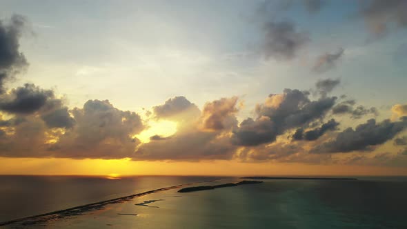 Wide angle birds eye abstract shot of a sunshine white sandy paradise beach and aqua blue ocean back