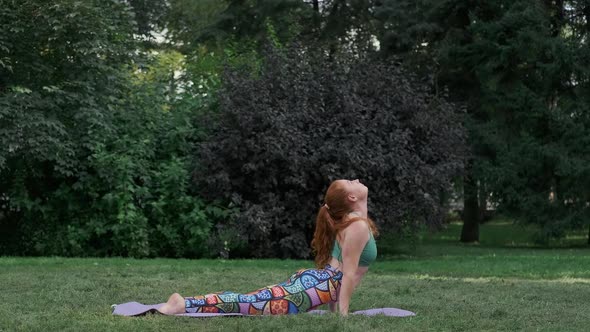 Redhead Woman Doing Yoga in Fresh Air