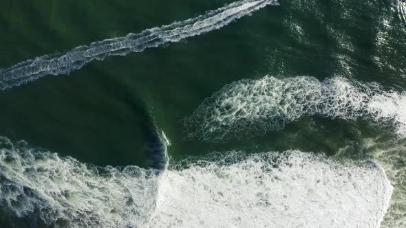 Aerial Topdown Survey of a Number of Speedboats Moving Fast By the Green Water Surface