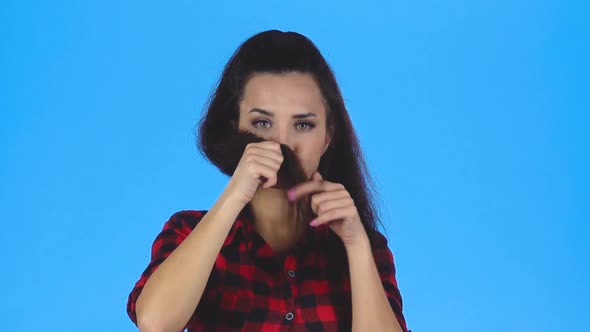 Young Woman Is Making Moustache From Her Hair. Slow Motion