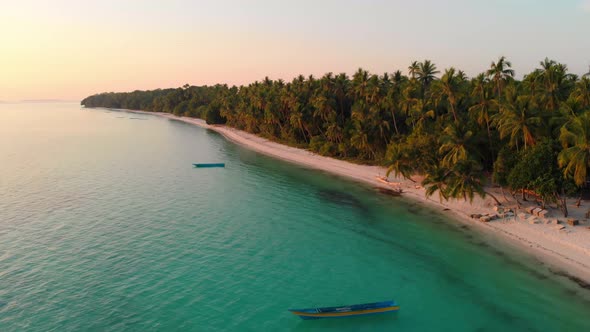 Aerial: uncontaminated white sand beach sunset at Wab Kei Islands Indonesia