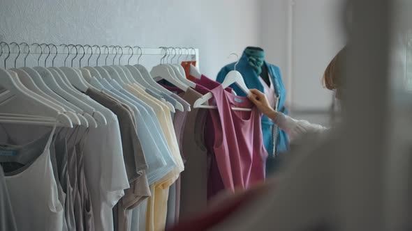 Young Woman Choosing Clothes in Store