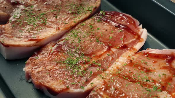 Seasoning Added To Pork Chops With Sauce And Tray Taken