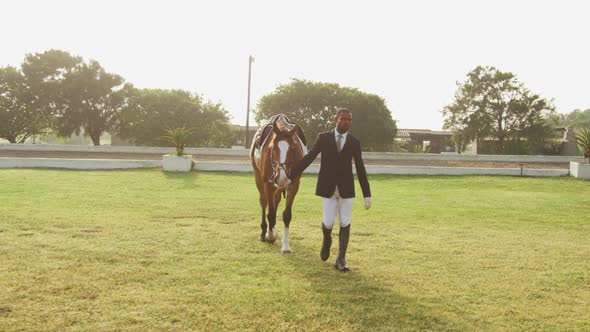 African American man walking with his Dressage horse