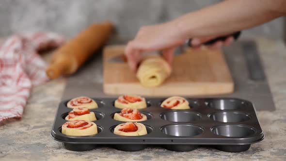 Female Hands Making Buns with Berry Jam.