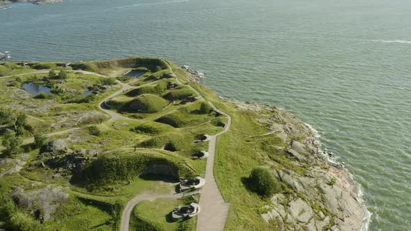 Aerial view around the cannons and the south coast of Suomenlinna fortress island, on a sunny, summe