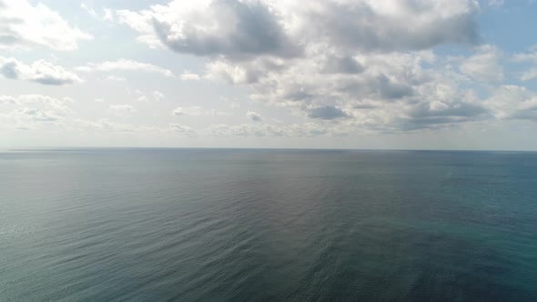 Aerial: a View From a Height of the Sea Against the Backdrop of a Cloudy Sky