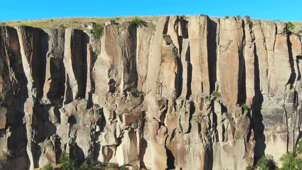 Aerial Deep Long Rift Canyon with Cleft Steep Rock Walls and High Cliff Gorge