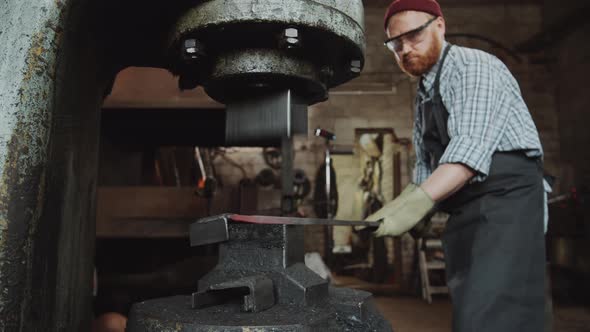 Blacksmith Working with Power Hammer