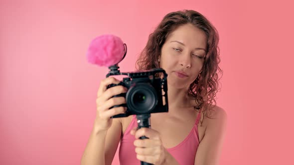 Portrait of a Young Beautiful Woman Using a Video Camera